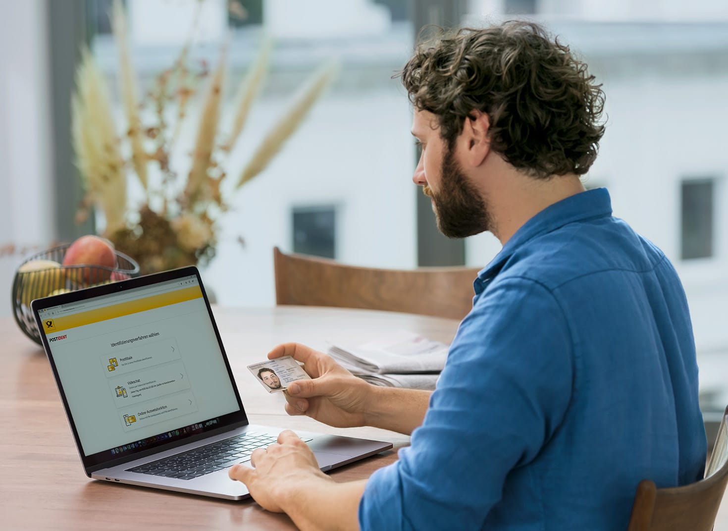 A man using his laptop to access a DHL service portal online.